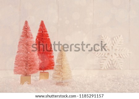 Image of miniature Christmas trees on a vintage textured wooden background
