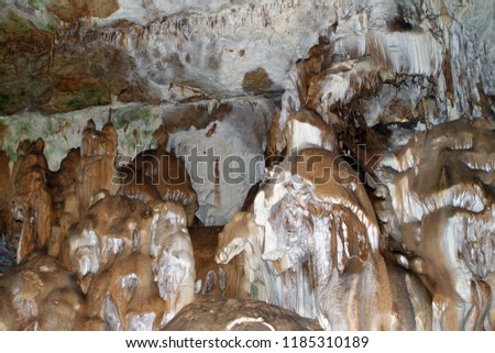 Natural texture image of wonderful natural cave with light brown walls and formations of stalagmites and stalactites in it - Marble Cave, Crimea