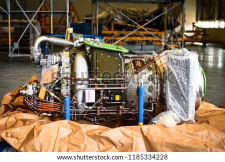 APU means auxiliary power unit. It is located on tailend of commercial aircrafts. It is actually a small jet engine. The APU is a small jet engine the larger jet engines. Royalty-Free Stock Photo #1185334228