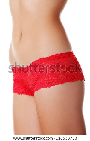 Fit woman body in red panties, isolated on white