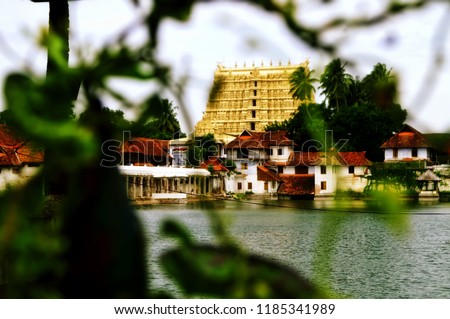 Image depicting the gopuram of the Lord Vishnu temple of Padmanabhaswamy along with the temple pond located at the city center of Trivandrum located in the Indian state of Kerala