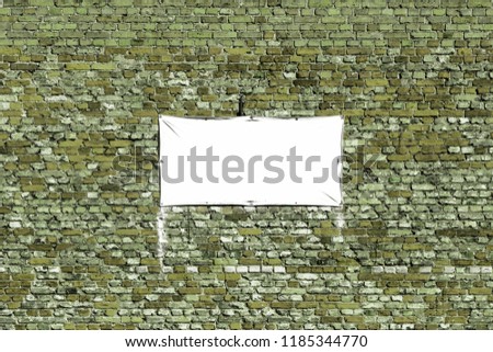 white banner on a brick wall
