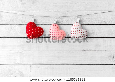 Heart Fabric hang over white wood background