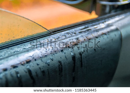 Raindrops on the leather upholstery of the car. Luxury car black leather texture interior  background