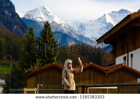 Beautiful girl photographer taking photos in Switzerland