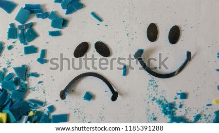 Worried and Smiling face in blue chips and powder on white background