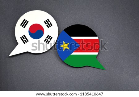 South Korea and South Sudan flags with two speech bubbles on dark gray background