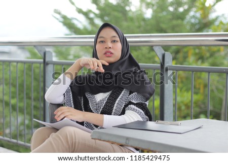 Asian girl wearing hijab holding note board to study. education concept