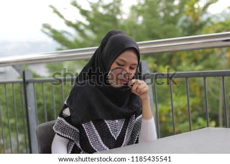 Young Asian girl studying at outdoor balcony. Education concept. 