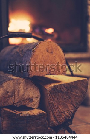 Small pile of firewood stacked next to the fire place at home