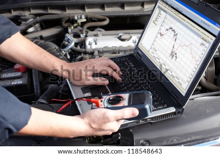 Professional car mechanic working in auto repair service. Royalty-Free Stock Photo #118548643