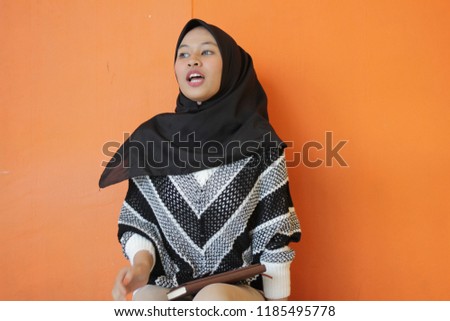 Asian portrait of a young girl wearing black hijab with multiple expression