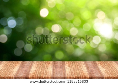 Wooden table top on green nature background