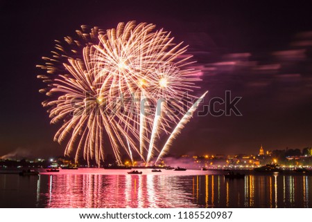 Fireworks in the night sky over the river