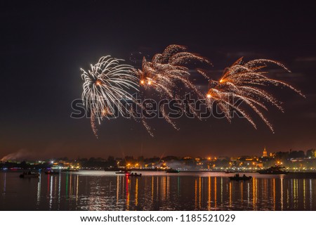 Fireworks in the night sky over the river