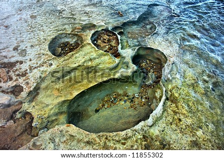 "Craters" on rocky sea beach. Shot in Sodwana Bay Nature Reserve, KwaZulu-Natal province, Southern Mozambique area, South Africa.