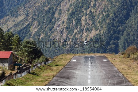 The aircraft is landing on the runway of the Tenzing-Hillary airport Lukla - Nepal, Himalayas