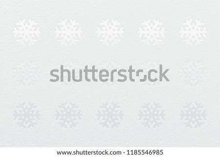 Snowflake shape on white texture paper background. The snowflake look like covered by snow on glass carving. Can be use for winter season background or Christmas festival background.