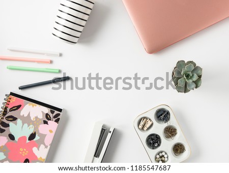 Pretty and feminine pink and mint green desk flat lay photo for a blog header or social media post.