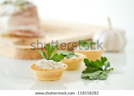tartlets with twisted bacon on a white background