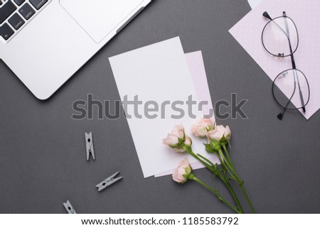 Empty white card with glasses and flowers on grey background in vintage style