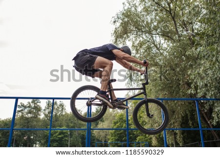 Bmx rider performing jump at ramp on skatepark