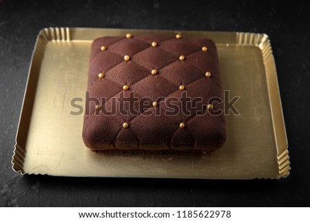 Chocolate cake in the form of a square. Assortment of confectionery.