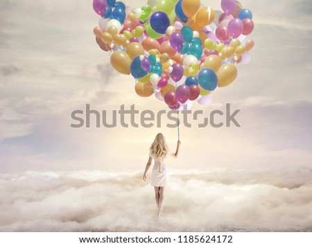 Dreamy image of a young blonde beauty walking in clouds