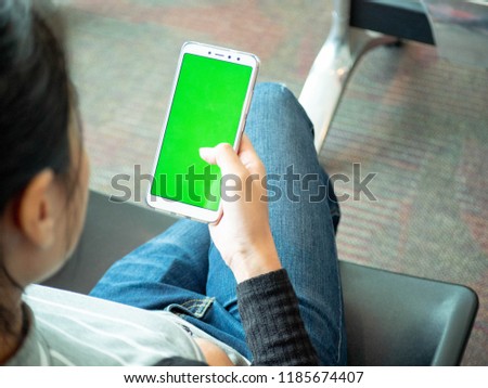Woman using cell phone for online shopping at airport. commerce concept and online buy or application