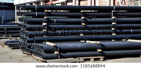 Plastic pipes in stock of finished products stacked in packs Royalty-Free Stock Photo #1185688894