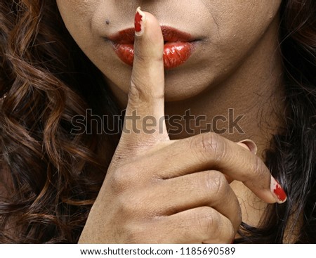woman with finger over mouth gesture keeping quiet stock photography stock photo