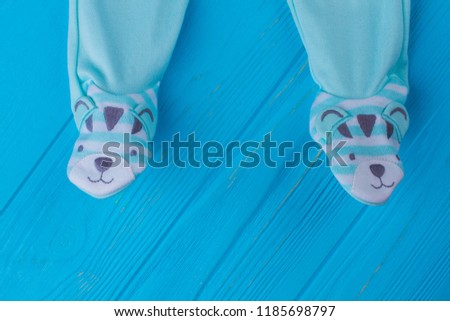 Footie pajamas for baby boys sleep. Close up. Blue wood background.