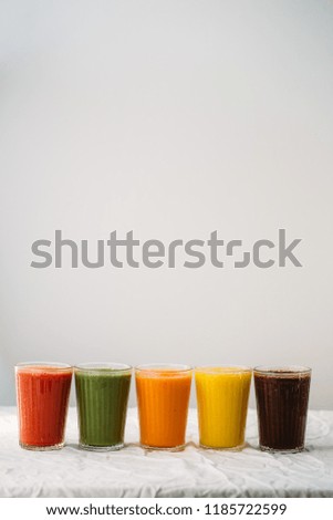Colorful smoothies in glass with fresh tropical fruit and superfoods