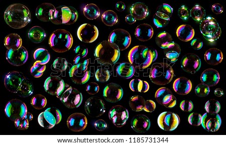 soap bubbles isolated on black background .