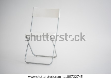 white plastic chair in a bright room
