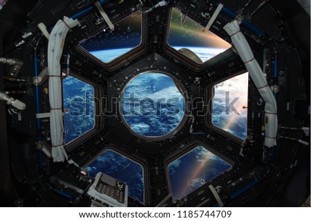 Fascinating sunrise on earth. Spaceship window view. Elements of this image furnished by NASA.
