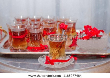 tea in eastern glass on the silver salver on the white tablecloth, Arabic, Turkish, Azerbaijani customs