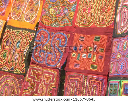 Close up of several tapestries hand made by the Kuna Indians in a rural market in Panama

 Royalty-Free Stock Photo #1185790645