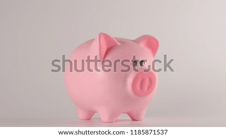 Pink piggy moneybox on a white background