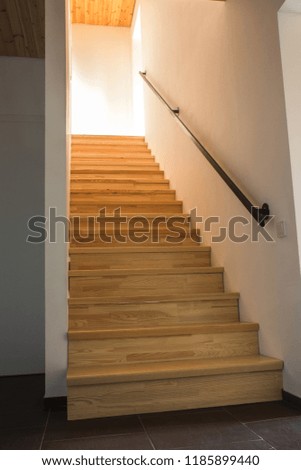 A stairs in a new home building with sunshine throught window, interior in new luxury home. 