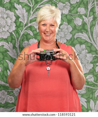 Senior Woman Holding Camera, Indoor