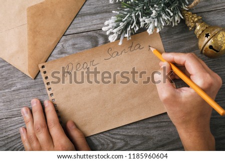 Letter to Santa Claus. Christmas decorations and a sheet of paper with a place for greeting on an old board, top view
