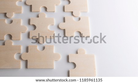 puzzles on a wooden background. Concept business. Idea: working in a team. Close up.