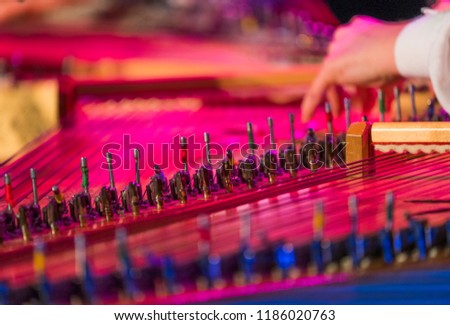 Hand playing on kokle a Latvian plucked string instrument belonging to the Baltic box zither family. Royalty-Free Stock Photo #1186020763