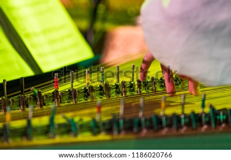 Hand playing on kokle a Latvian plucked string instrument belonging to the Baltic box zither family. Royalty-Free Stock Photo #1186020766