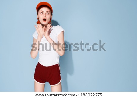 woman in red cap, shorts and t-shirt                             