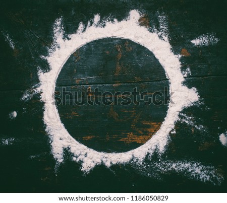 round flour frame on old black wooden retro background with copy space