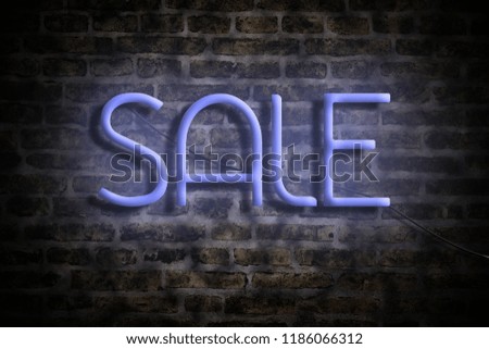 Neon inscription Sale on the background of a brick wall. The concept of a business sale. Background.