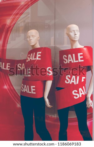 In Selective Focus of Red text SALE  Wrapping on Mannequin in Showroom at Summer Fast Discounts Zone in the Department Store Background. 
