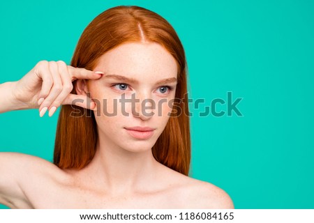 Advertising concept. Close-up portrait of nice cute attractive red-haired girl with shiny pure clean skin, thinking about plastic surgery, isolated over green turquoise background